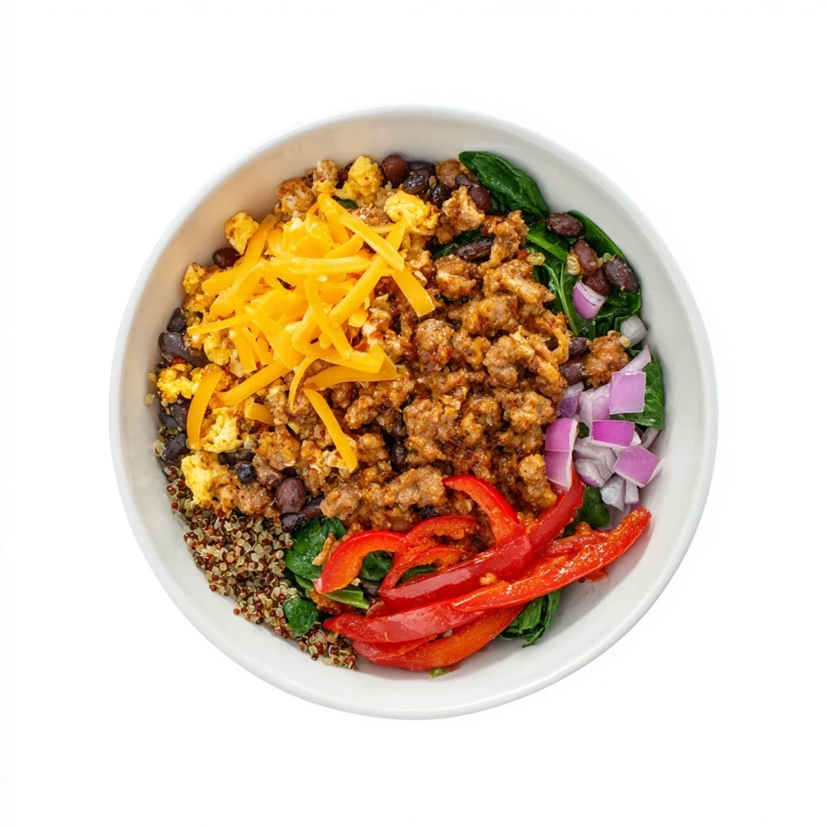 Steamy high protein breakfast bowl packed with scrambled eggs, crumbled sausage, diced bell peppers, spinach, and black beans layered over wholesome quinoa.