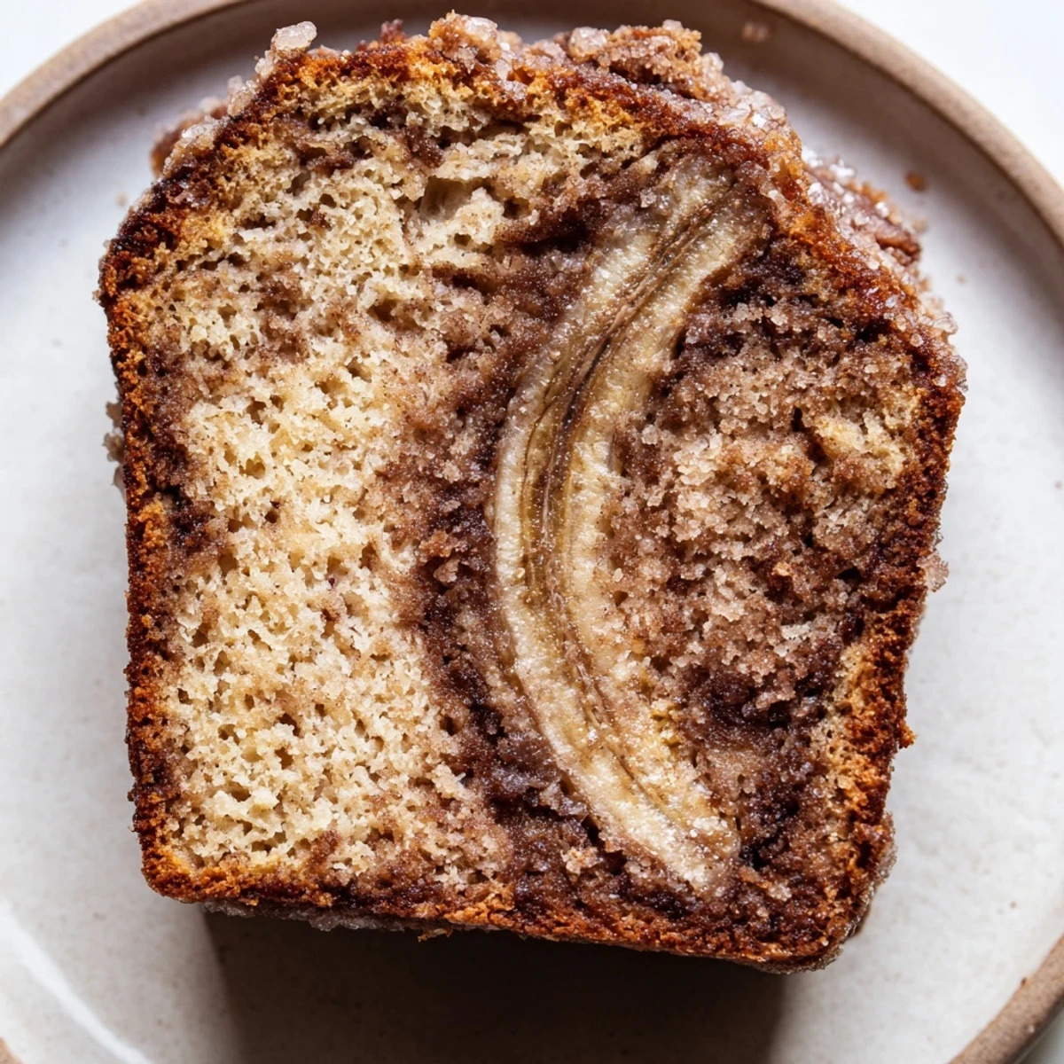 Warm cinnamon sugar swirl banana bread with caramelized streusel topping fresh from the oven