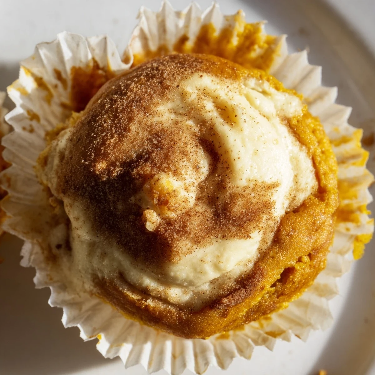 Golden chai pumpkin cheesecake muffins with swirled spiced cream cheese filling