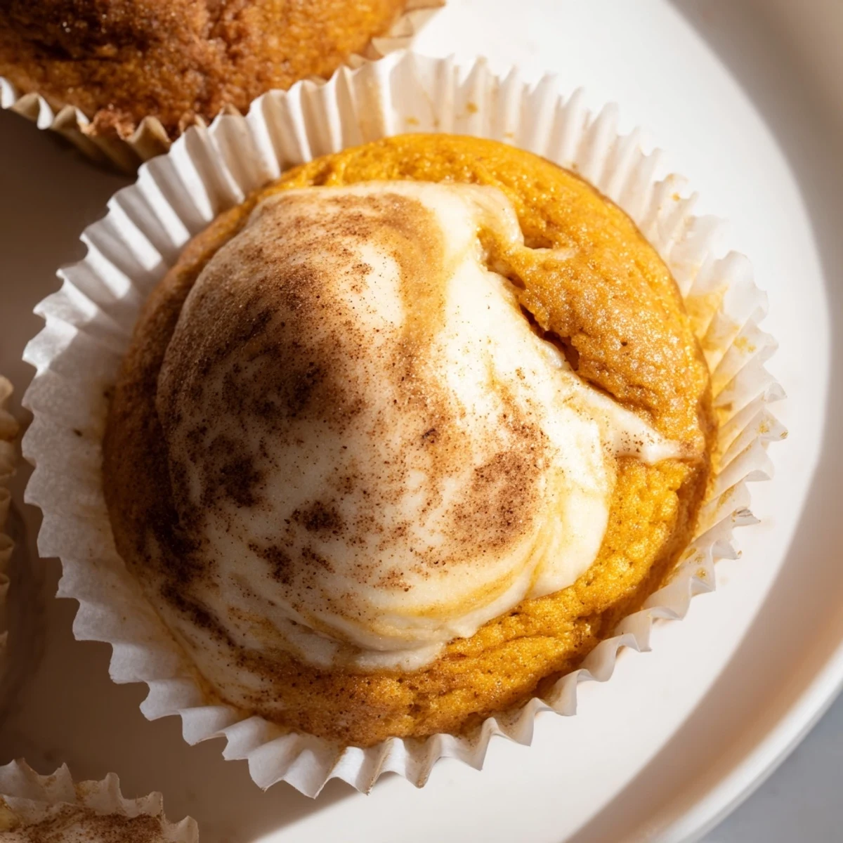 Homemade chai pumpkin cheesecake muffins on a rustic autumn baking wire rack
