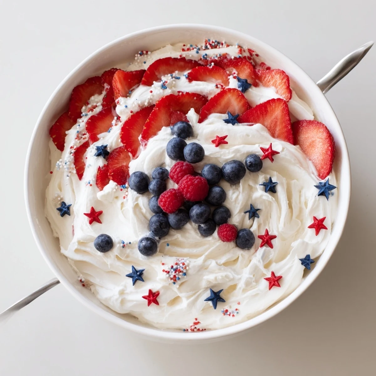 How To Make Star Spangled Cheesecake Dip creamy, garnished with fresh fruit and crackers