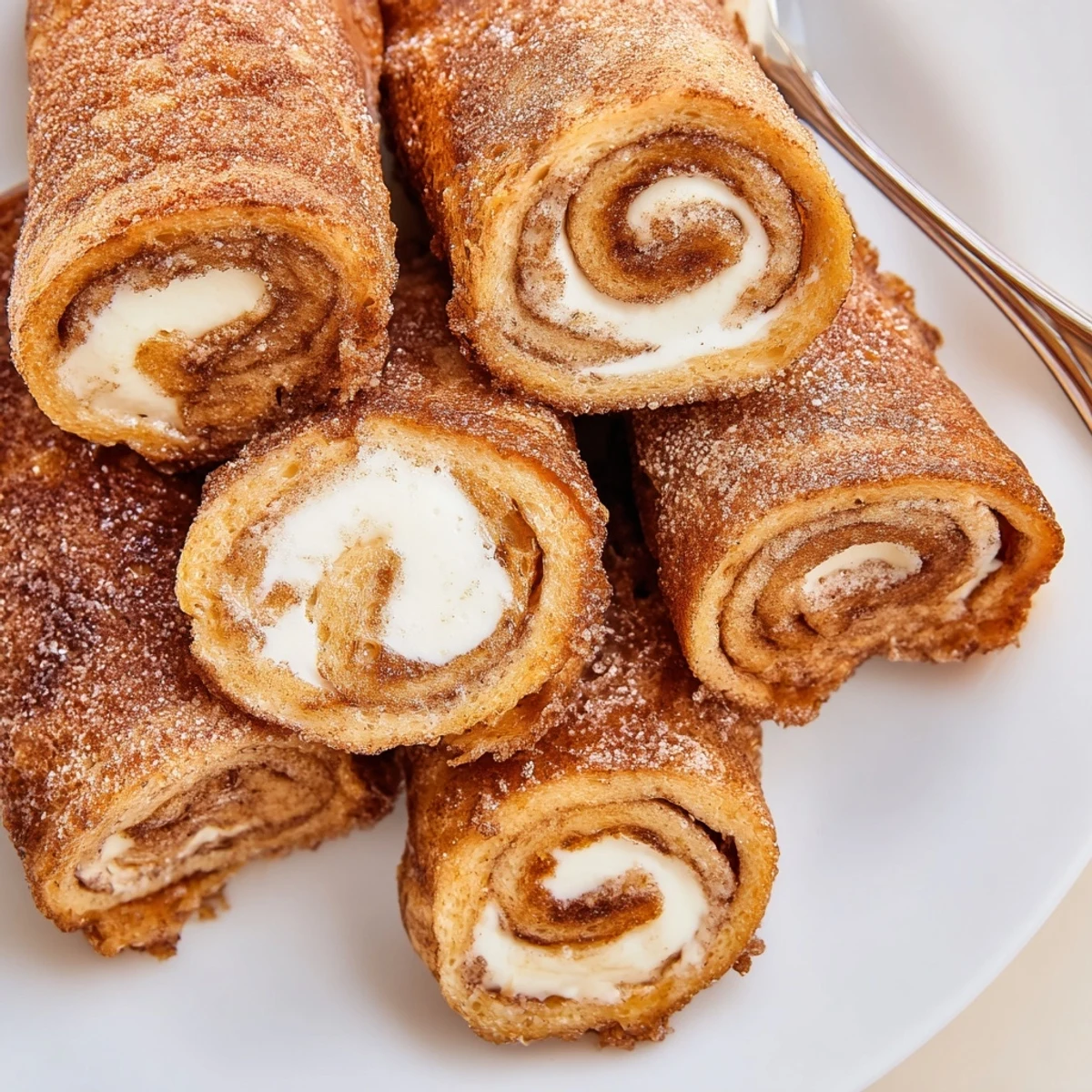 Cinnamon Roll French Toast Roll Ups golden, cinnamon-crusted, served with warm maple syrup