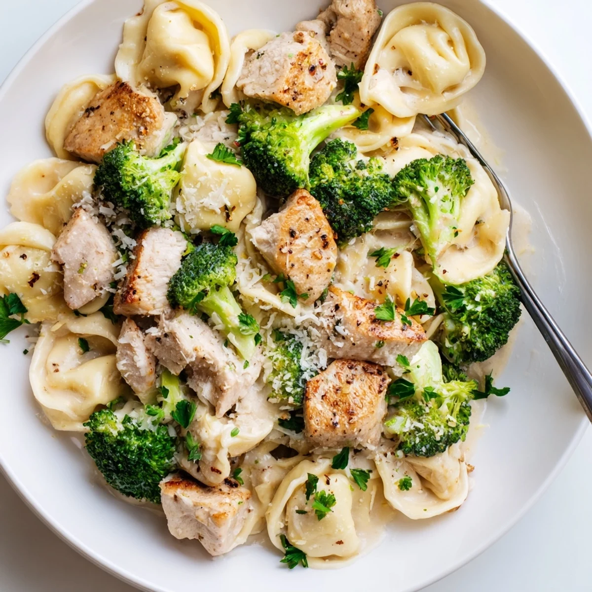 Warm Creamy Garlic Parmesan Tortellini Chicken Broccoli Recipe, juicy chicken and crisp broccoli.