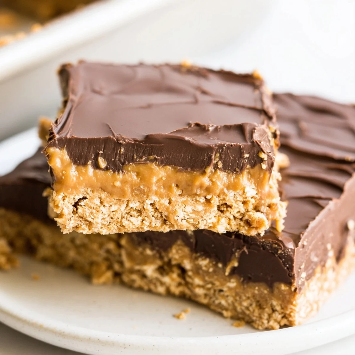 No Bake Peanut Butter Bars on parchment, glossy chocolate, chilled and sliced