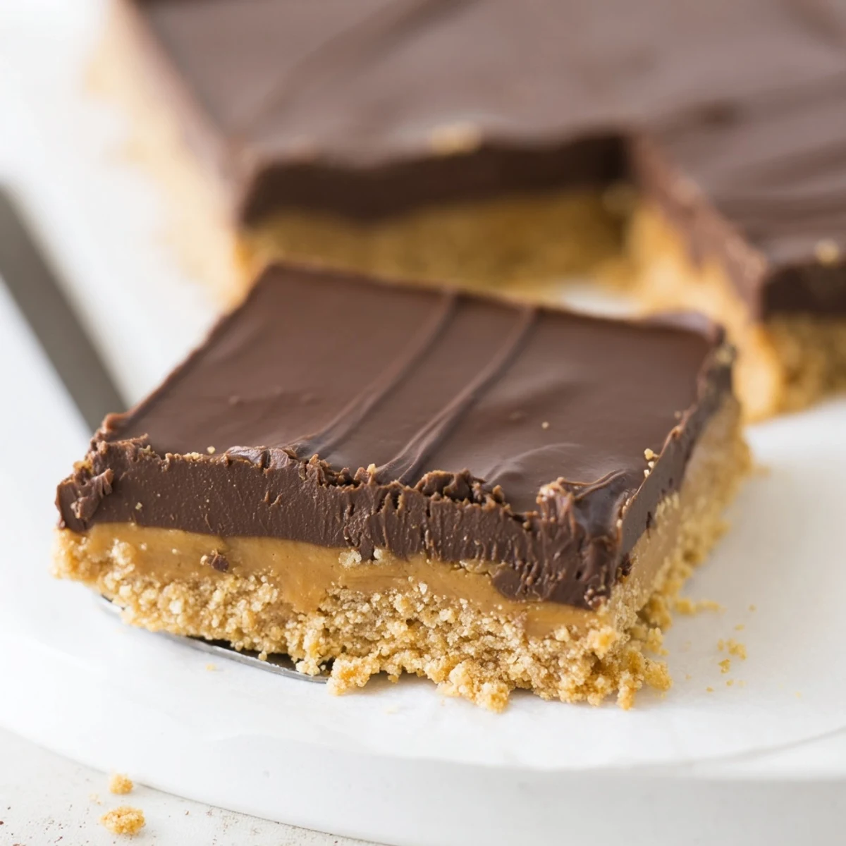 Stacked No Bake Peanut Butter Bars showing creamy peanut center and sheen