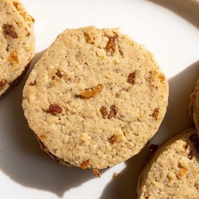Crumbly espresso shortbread cookies studded with sweet toffee bits beside a coffee mug