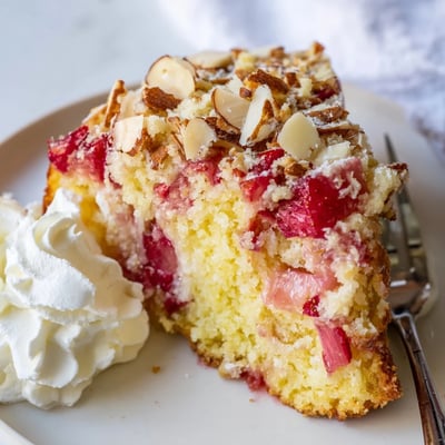 Slice of ultimate spring baking treat topped with sweet strawberry rhubarb and streusel